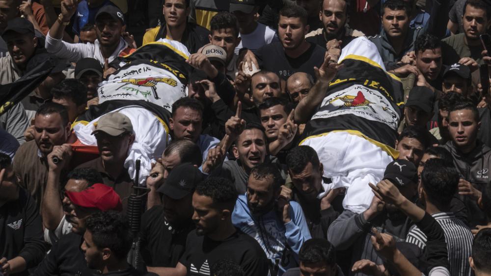 Palestinians carry the bodies of Islamic Jihad commander Ali Ghali, left, (AP Photo/Fatima Shbair) and his brother, Mohammed Ghali, both killed in an Israeli airstrike in Khan Younis, southern Gaza Strip, Thursday, May 11, 2023. 