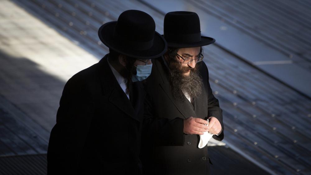 In this Thursday, Feb. 4, 2021 file photo, two ultra-Orthodox Jewish men walk in Antwerp, Belgium. Antisemitism is on the rise in Belgium since the Hamas attack against Israel that triggered a war in Gaza. (AP Photo/Virginia Mayo, File)