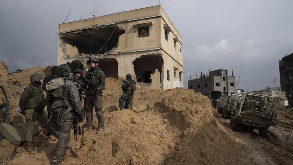 Israeli soldiers stand outside a building during the ground offensive on the Gaza Strip in Khan Younis, Saturday, Jan. 27, 2024. (AP Photo/Sam McNeil)