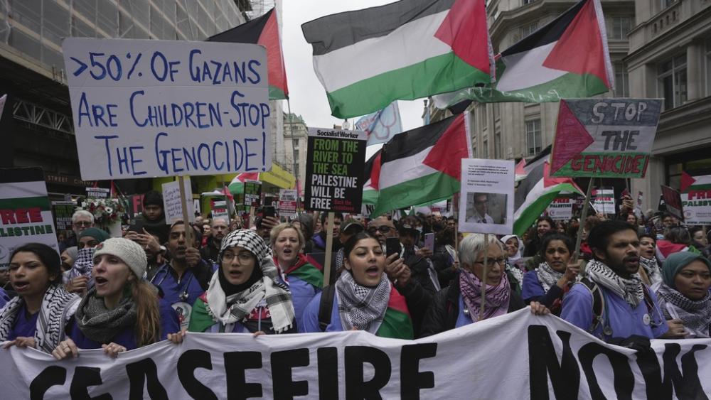 Pro-Palestinian protesters hold up banners, flags and placards during a demonstration in London, Saturday, Feb. 3, 2024 as they demand for a full cease fire and an end to the siege of Gaza. (AP Photo/Kin Cheung)