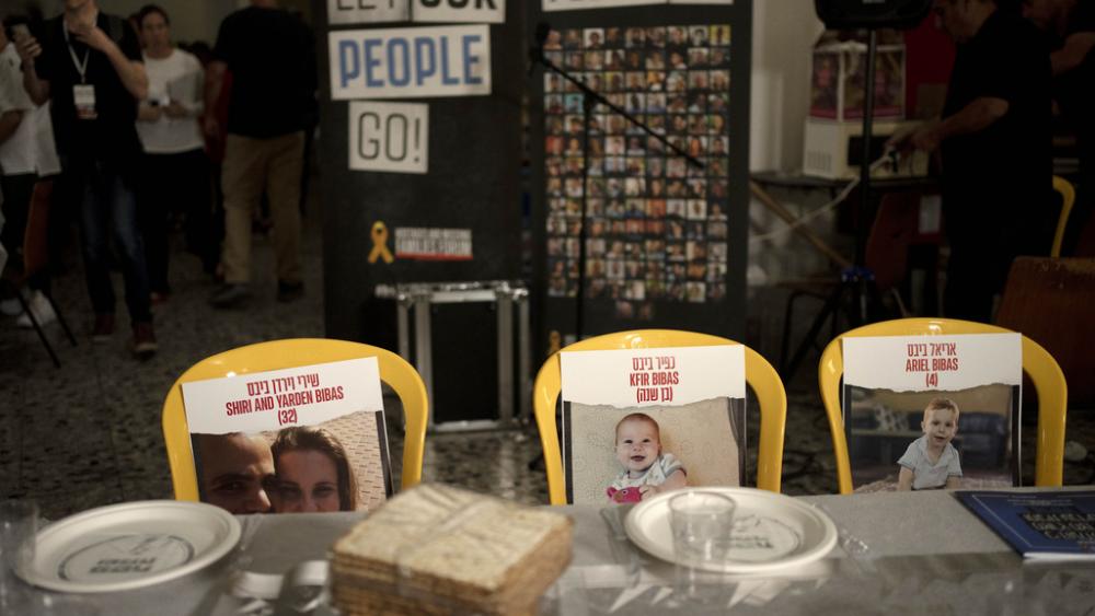 Chairs for the Bibas family, hostages held in Gaza, are seen at a Passover seder table set, Thursday, April 11, 2024. (AP Photo/Maya Alleruzzo, File)