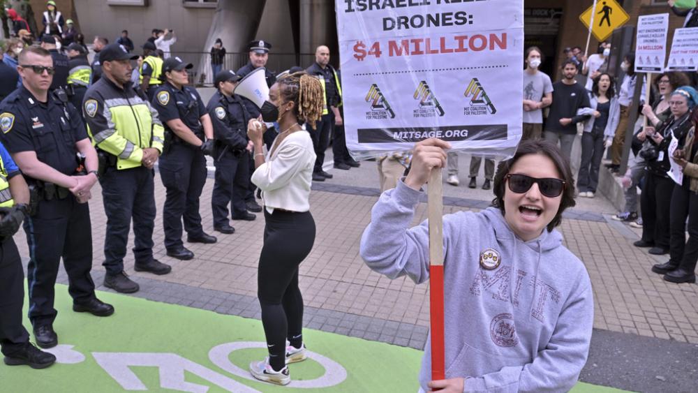 Pro-Palestinian demonstrators face of with a line of police outside the Stata Center at MIT, Thursday, May 9, 2024, in Cambridge, Mass. (AP Photo/Josh Reynolds)