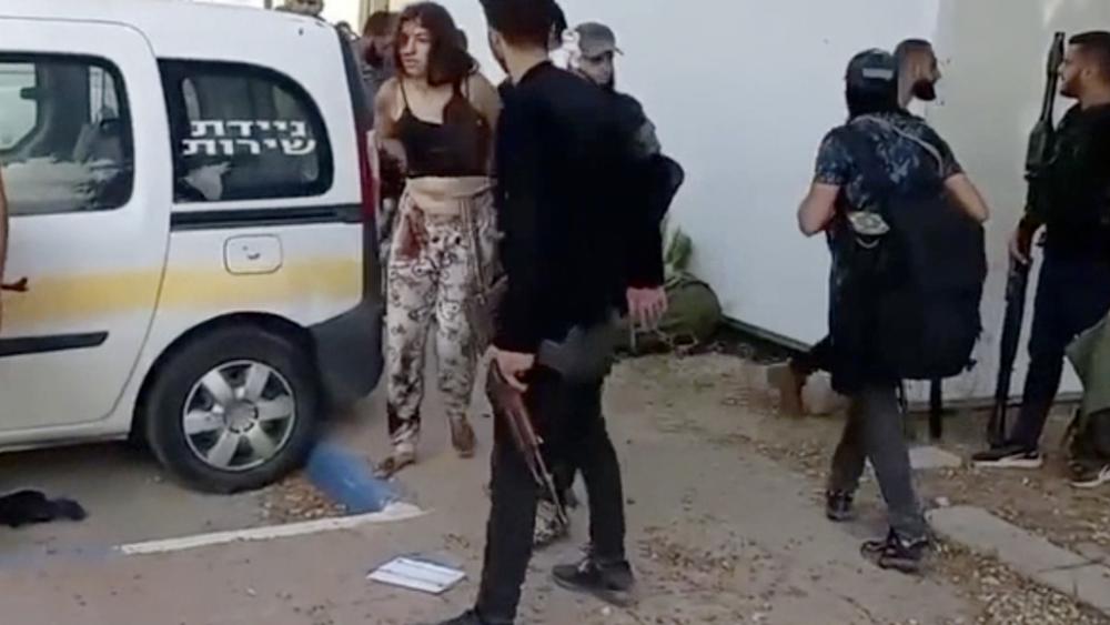 In this image taken from video provided by the Hostage Families Forum, an Israeli female soldier, from the Nahal Oz military base, is marched to a vehicle by Hamas after she was taken captive on Oct. 7, 2023. (Hostage Families Forum via AP)