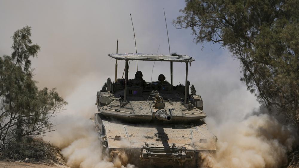 Israeli soldiers drive a tank near the Israeli-Gaza border, in southern Israel, Wednesday, May 29, 2024. (AP Photo/Tsafrir Abayov)