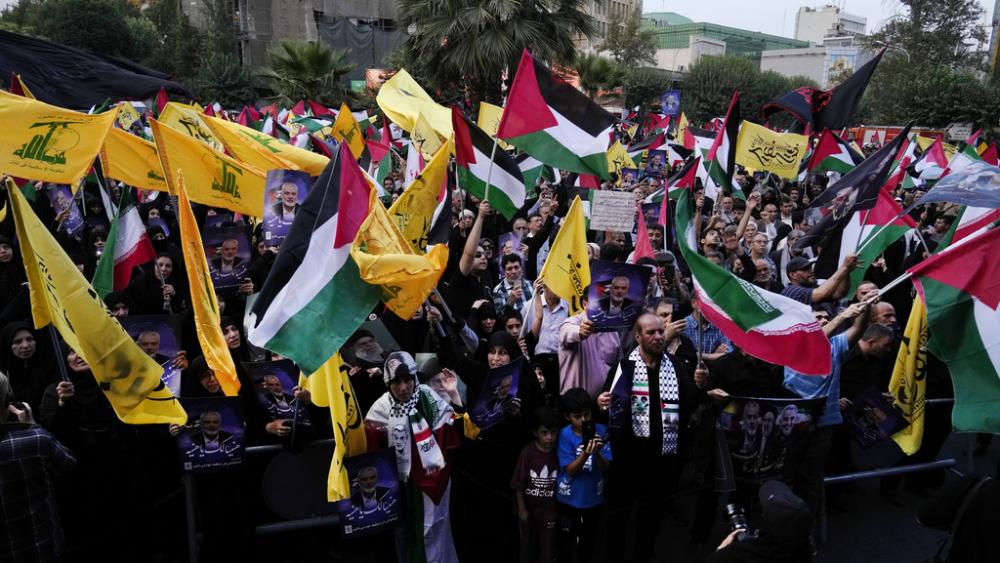 Iranian protesters wave Iranian, Palestinian and Lebanon&#039;s militant Hezbollah group flags in a demonstration to condemn killing of Hamas leader Ismail Haniyeh, at Felestin (Palestine) Sq. in Tehran, Iran, Wednesday, July 31, 2024. (AP Photo/Vahid Salemi)