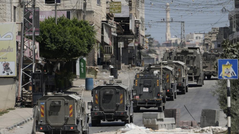 A column of Israeli Army armored vehicles leave following a military operation in the West Bank town of Tubas, Wednesday, Aug. 14, 2024. (AP Photo/Majdi Mohammed)