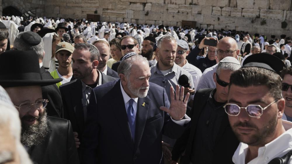 US ambassador to Israel Mike Huckabee, center, visits the Western Wall, the holiest site where Jews can pray, in the Old City of Jerusalem, Friday, April 18, 2025. (AP Photo/Leo Correa)