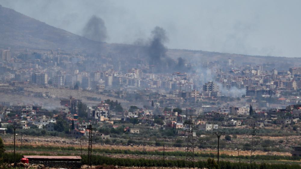 Smoke rise from clashes between Syrian government forces and Druze militias in Sweida city, southern Syria, Tuesday, July 15, 2025. (AP Photo/Omar Sanadiki)