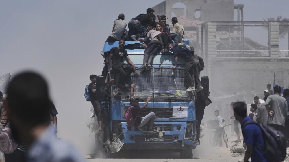Palestinians hold onto an aid truck returning to Gaza City from the northern Gaza Strip on Tuesday, July 22, 2025. (AP Photo/Jehad Alshrafi)