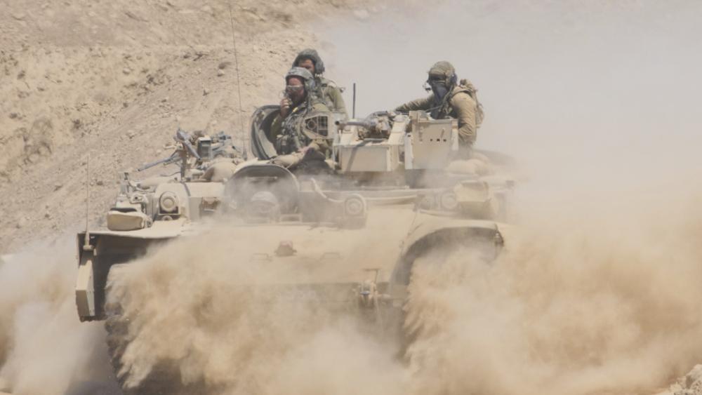Israeli soldiers drive on their armored personnel carrier back from inside the northern Gaza Strip into southern Israel, Tuesday, July 29, 2025. (AP Photo/Ariel Schalit)