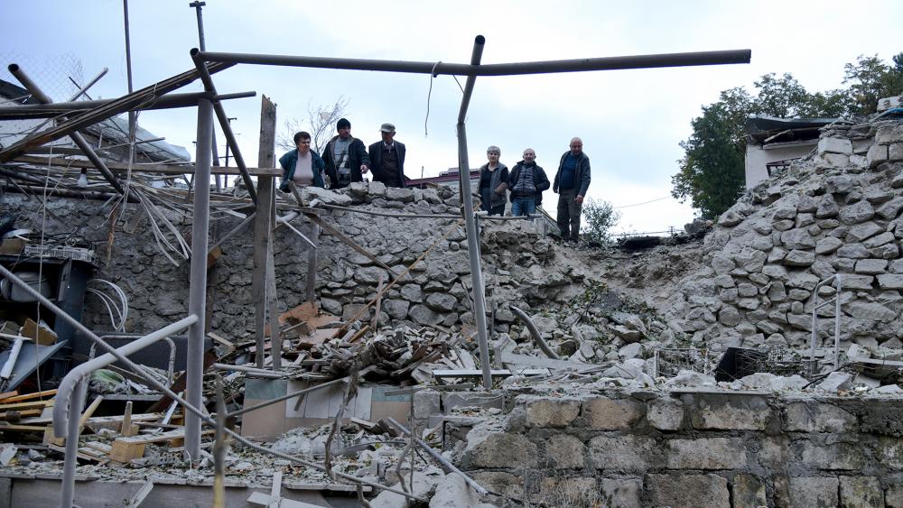 Men look at the damage in a residential area after shelling by Azerbaijan&#039;s artillery during a military conflict in self-proclaimed Republic of Nagorno-Karabakh, Sunday, Oct. 4, 2020.David Ghahramanyan/NKR InfoCenter PAN Photo via AP)