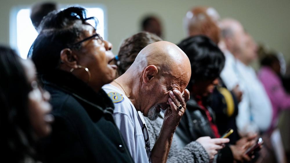 People gather for a vigil near the scene where a container ship collided with a support on the Francis Scott Key Bridge, at Mount Olive Baptist Church in Dundalk, Md., Tuesday, March 26, 2024. (AP Photo/Matt Rourke)