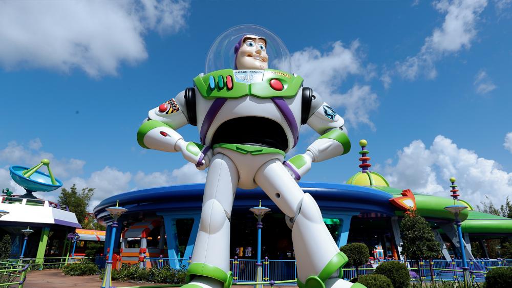 Buzz Lightyear stands near the entrance to the Alien Swirling Saucers ride at Toy Story Land in Disney&#039;s Hollywood Studios at Walt Disney World in Lake Buena Vista, Fla. (AP Photo/John Raoux)