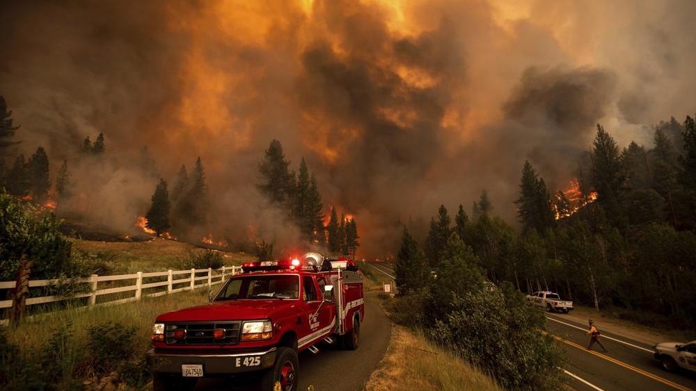 Firefighters battle the Tamarack Fire in the Markleeville community of Alpine County, Calif., on Saturday, July 17, 2021. (AP Photo/Noah Berger)