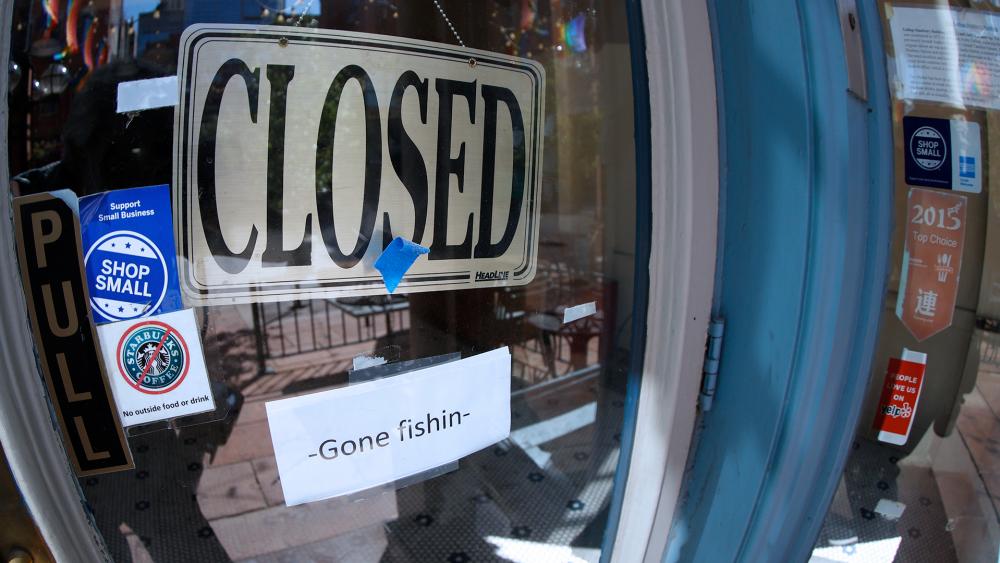 A closed sign hangs in the door of The Market, a long-time restaurant and food store located in Larimer Square, that has closed because of the new coronavirus, June 18, 2020, in Denver. (AP Photo/David Zalubowski)