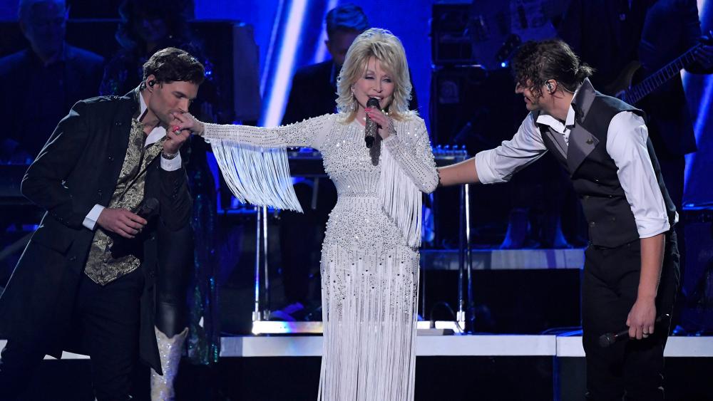 Dolly Parton performs &quot;God Only Knows&quot; with Joel Smallbone, left, and Luke Smallbone, right, of For King &amp; Country at the 53rd annual CMA Awards, Nov. 13, 2019. (AP Photo/Mark J. Terrill)
