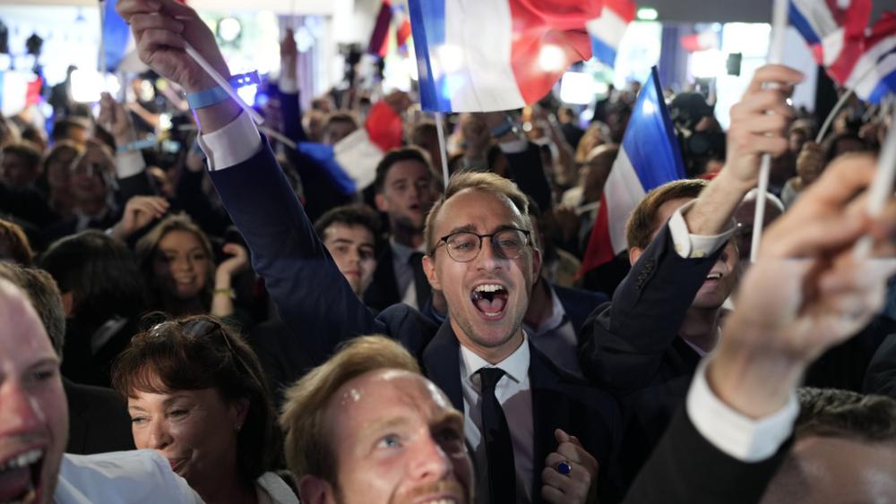 Supporters of French far-right National Rally react at the party election night headquarters, Sunday, June 9, 2024 in Paris. (AP Photo/Lewis Joly) 