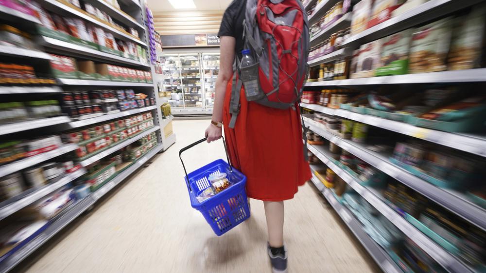 A shopper walks through a supermarket as grocery price inflation continues. (Press Association via AP Images)