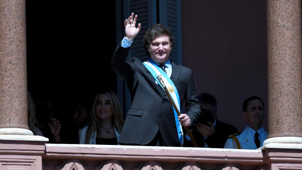 Argentina&#039;s newly sworn-in President Javier Milei waves to supporters from the balcony of the government house in Buenos Aires