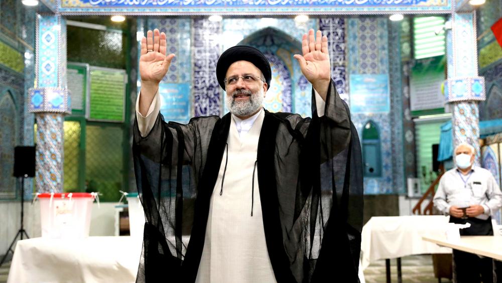 Ebrahim Raisi, a candidate in Iran&#039;s presidential elections waves to the media after casting his vote at a polling station in Tehran, Iran Friday, June 18, 2021. (AP Photo/Ebrahim Noroozi)