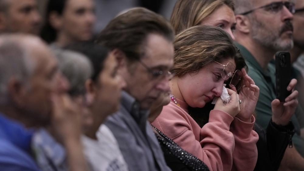Emily Birger wipes away tears during a vigil in Overland Park, KS for Sarah Milgrim and Yaron Lischinsky, Israeli Embassy staff members who were murdered in Washington, May 22, 2025. (AP Photo/Charlie Riedel)