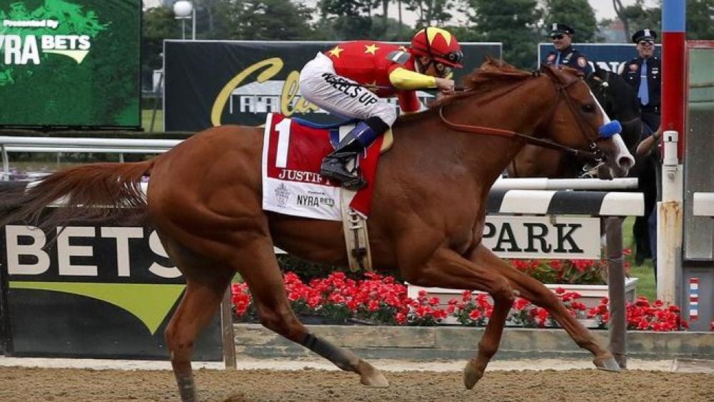 Justify, with jockey Mike Smith, crosses the finish line to win the 150th running of the Belmont Stakes horse race and becoming the 13th horse to win the Triple Crown.