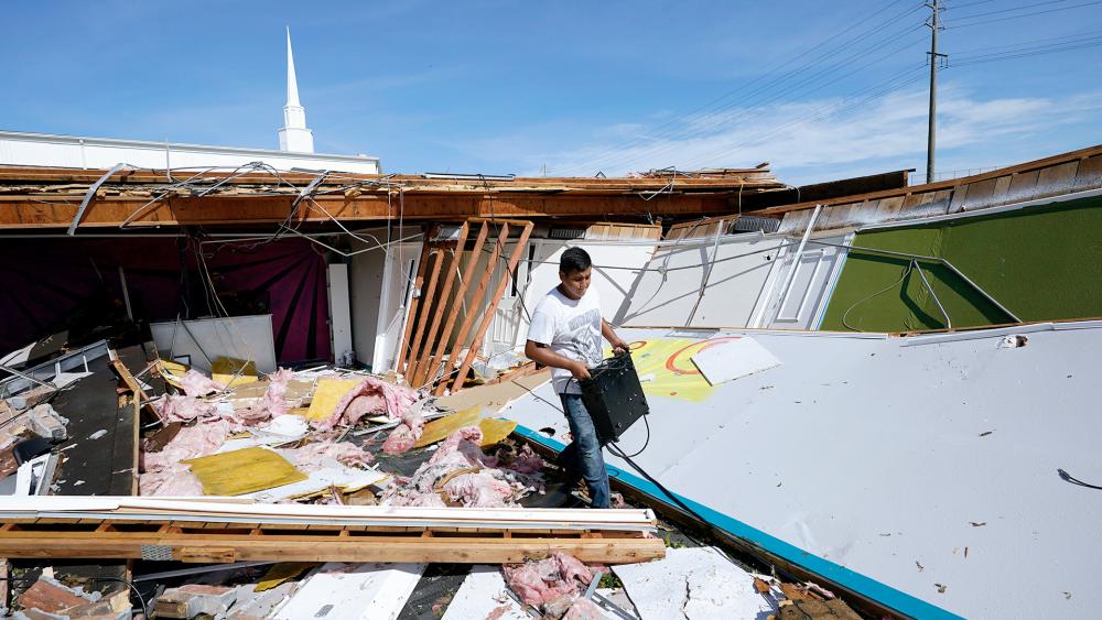Benjamin Luna helps recover items from the children&#039;s wing of the First Pentecostal Church that was destroyed by Hurricane Laura, Thursday, Aug. 27, 2020, in Orange, Texas. (AP Photo/Eric Gay)