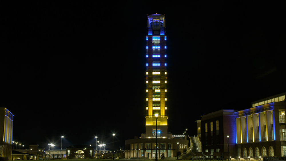 Image Credit: Liberty University/Blue and yellow shines bright from Freedom Tower as students lift up Ukraine in prayer.