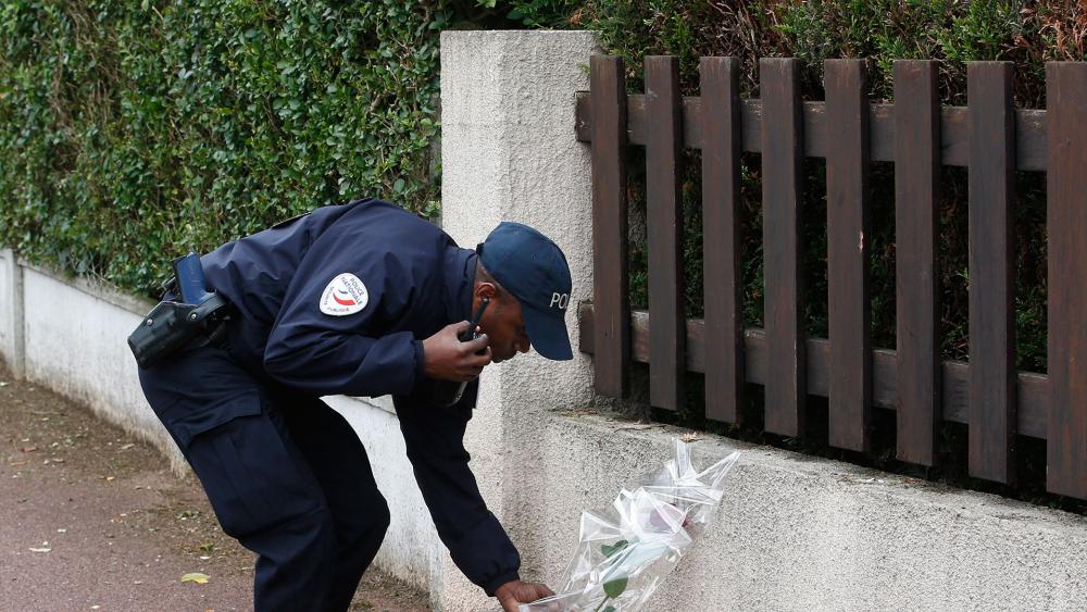French policeman pays tribute to slain colleagues, Associated Press photo