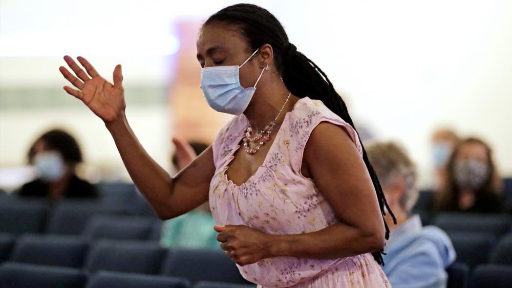 Sonia Falk prays during a Memorial Day service at Lakewood Chapel Church in Arlington Heights, Ill., Sunday, May 24, 2020 (AP Photo/Nam Y. Huh)