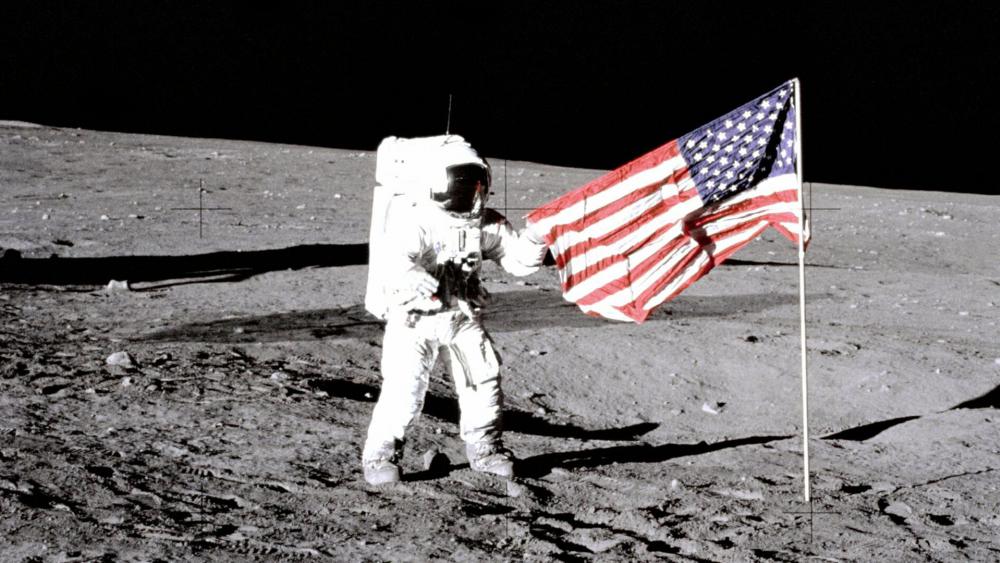 Charles &quot;Pete&quot; Conrad Jr., the third human to walk on the moon on the Apollo 12 mission, stands with the U.S. flag on the lunar surface. (Image courtesy: NASA) 