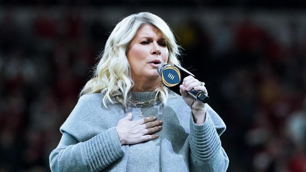 Natalie Grant sings the national anthem before the College Football Playoff championship football game between Alabama and Georgia, Jan. 10, 2022, in Indianapolis. (AP Photo/Darron Cummings)