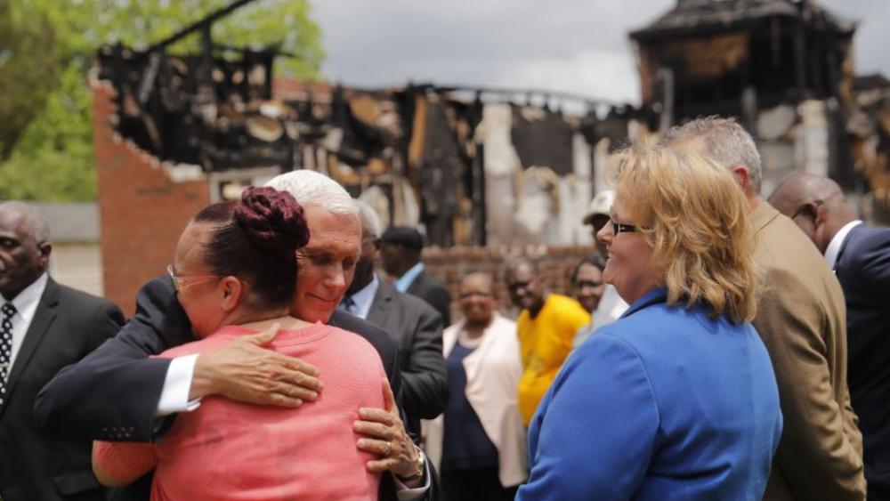 Vice President Mike Pence hugs a church member as he visits with three congregations at the Mt. Pleasant Baptist Church, which was burned along with two other nearby African American churches, in Opelousas, La., Friday, May 3, 2019. (AP Photo) 