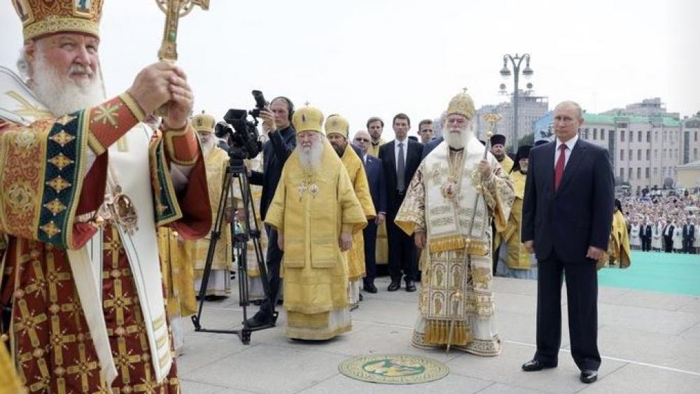 Russian Orthodox Church Patriarch Kirill, left, leads a religion service as Russian President Vladimir Putin, right, attends a ceremony marking the 1,030th anniversary of the adoption of Christianity.