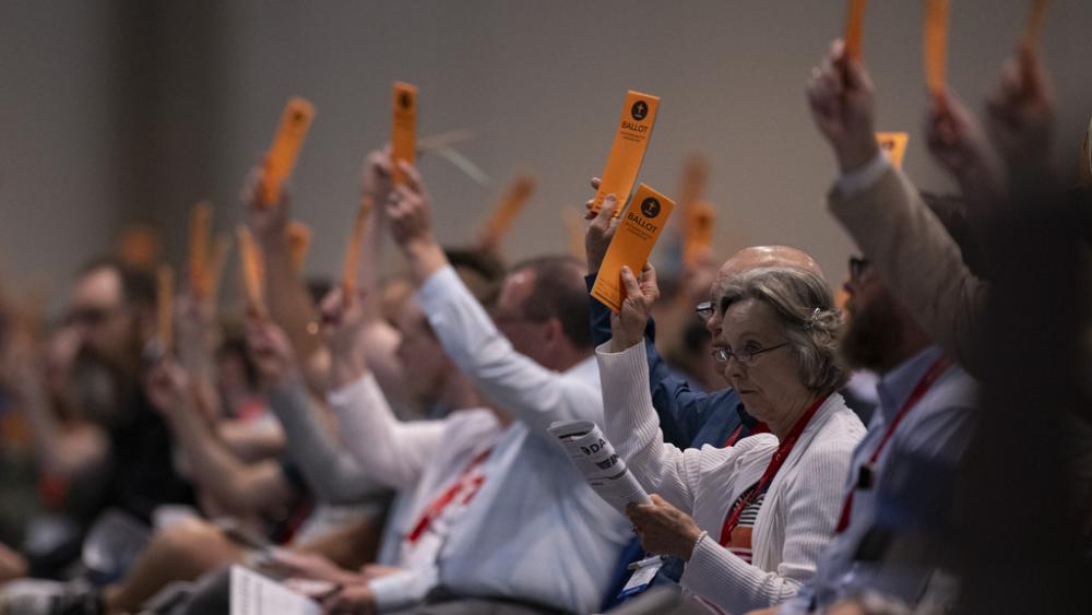 Messengers raise their ballots in support of a motion put up for vote during a Southern Baptist Convention annual meeting, June 11, 2024, in Indianapolis. (AP Photo/Doug McSchooler)