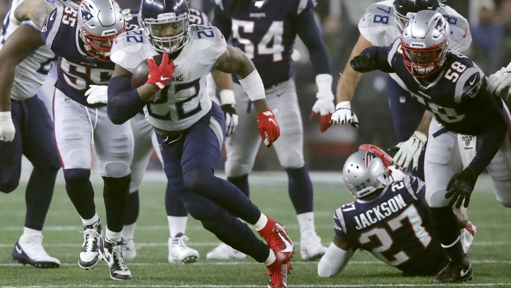 Tennessee Titans running back Derrick Henry runs from New England Patriots defenders in the first half of an NFL wild-card playoff football game, Saturday, Jan. 4, 2020, in Foxborough, Mass. (AP Photo/Charles Krupa)