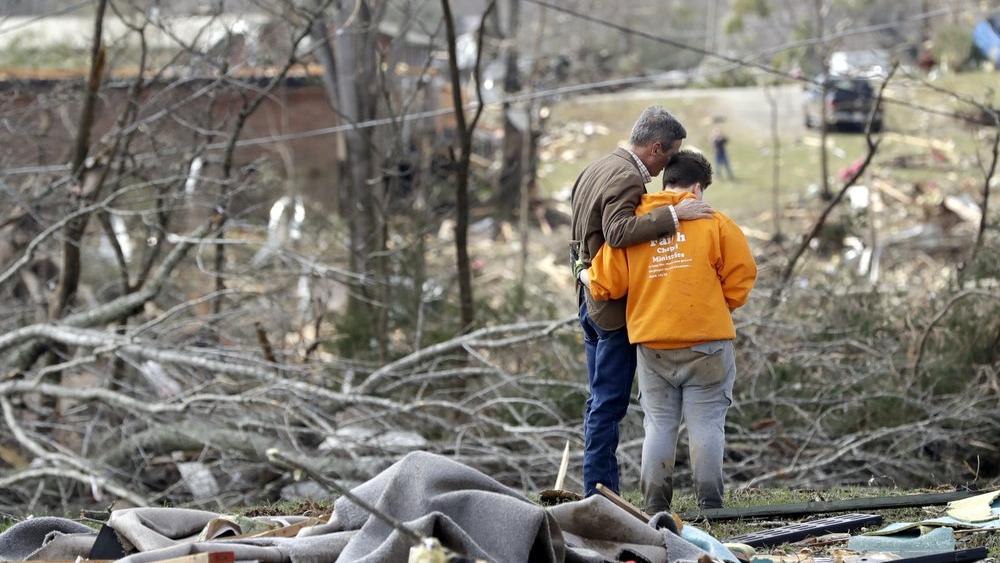 Tennessee Gov. Bill Lee, left, prays near Cookeville, Tenn. after tornadoes ripped across Tennessee early Tuesday (AP Photo/Mark Humphrey)