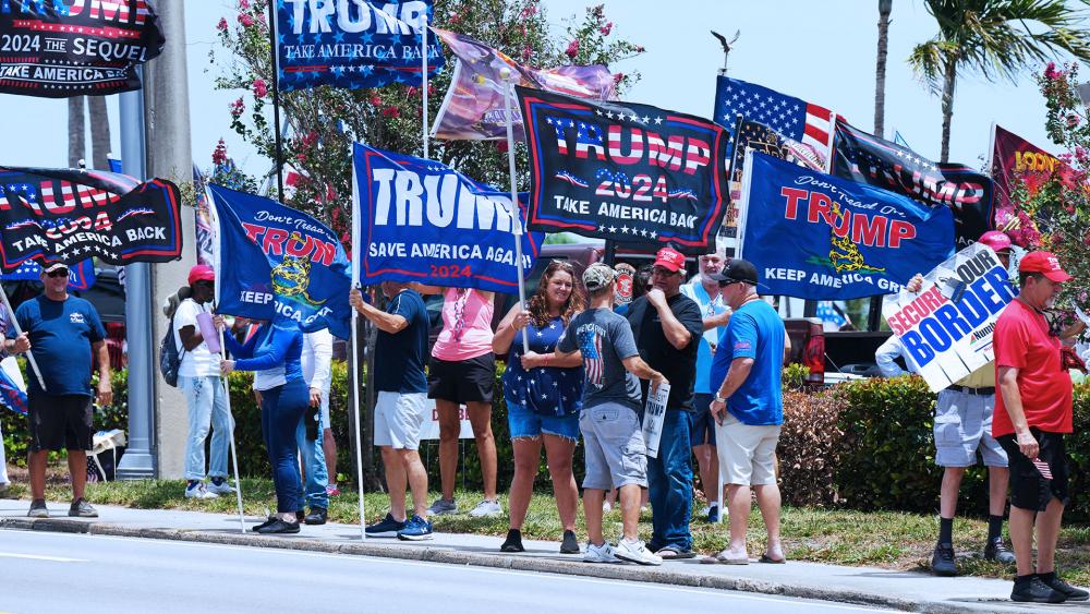 Supporters of former President Donald Trump gather along Southern Boulevard in West Palm Beach, Fla., Sunday, June 2, 2024. (AP Photo/Jim Rassol)