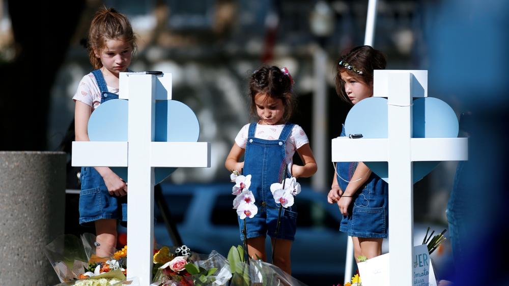 Children pay their respects at a memorial site for the victims killed in this week&#039;s elementary school shooting in Uvalde, Texas, Thursday, May 26, 2022. (AP Photo/Dario Lopez-Mills)