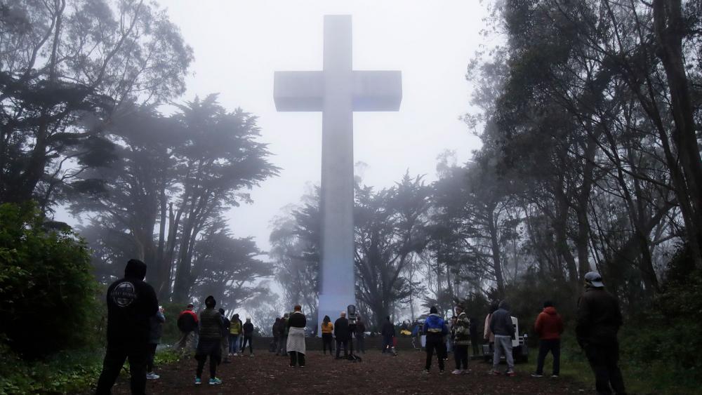 People gather at the Mount Davidson Cross in San Francisco, Sunday, April 12, 2020. Mount Davidson&#039;s annual Easter Sunrise Service was canceled for San Francisco&#039;s shelter in place orders over coronavirus concerns. (AP Photo/Jeff Chiu)