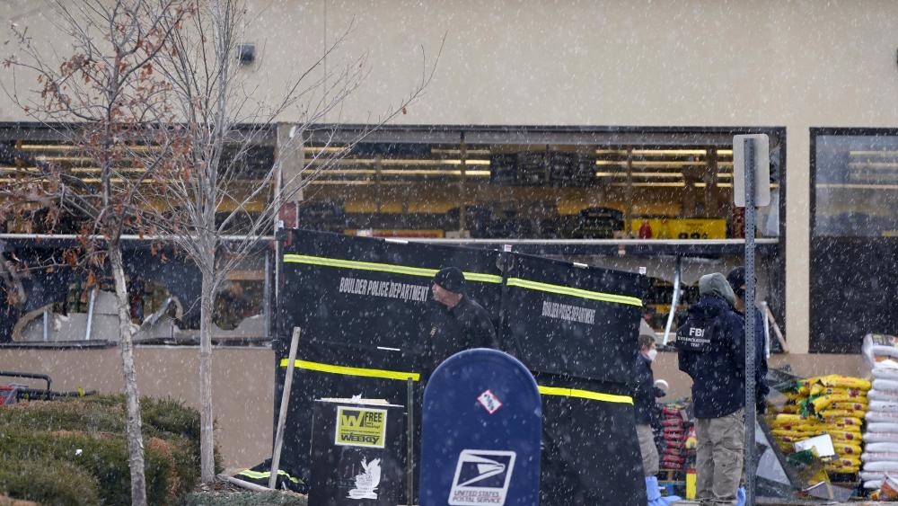 Police work on the scene outside of a King Soopers grocery store where a shooting in Boulder, Colo. (AP Photo/David Zalubowski)