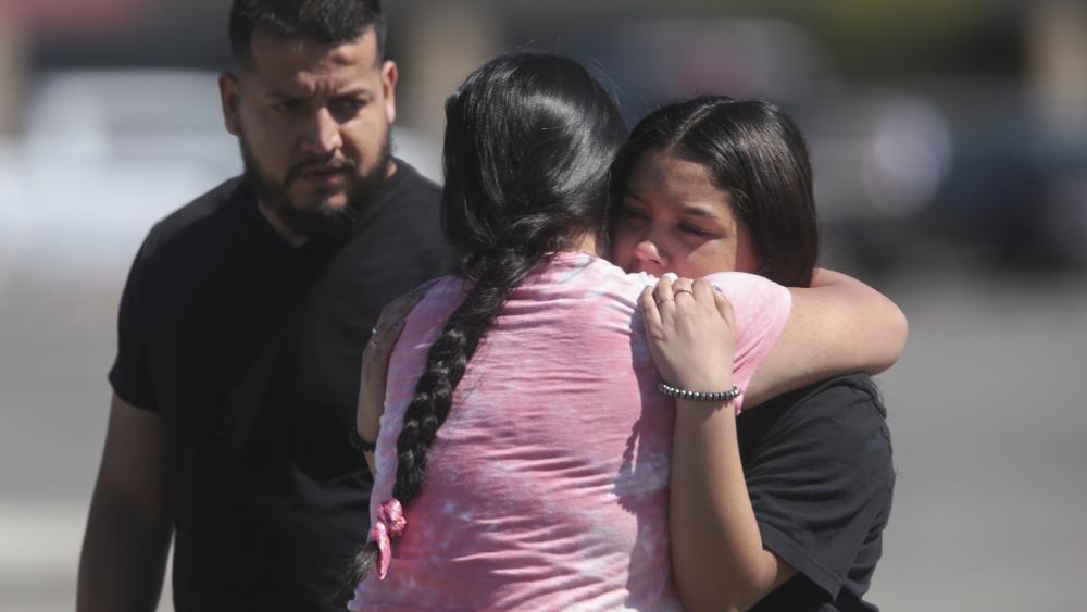 People embrace after a school shooting at Rigby Middle School in Rigby, Idaho on Thursday, May 6, 2021. (John Roark /The Idaho Post-Register via AP)