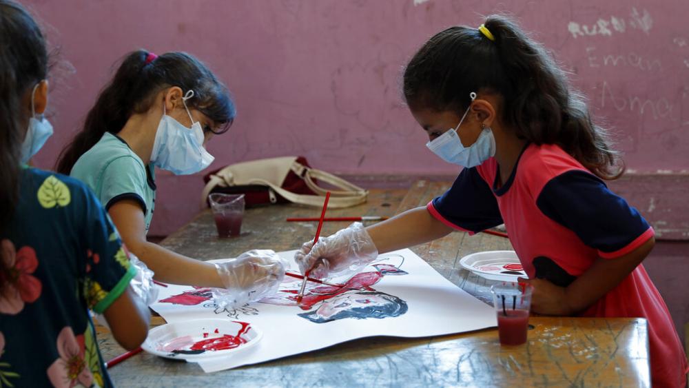 Students paint during an UNRWA summer camp at the Beach Preparatory School for girls, in the Shati refugee camp, Sunday, July 4, 2021. According to UNRWA it has started summer camps for 150,000 children in the Gaza Strip. (AP Photo/Adel Hana)