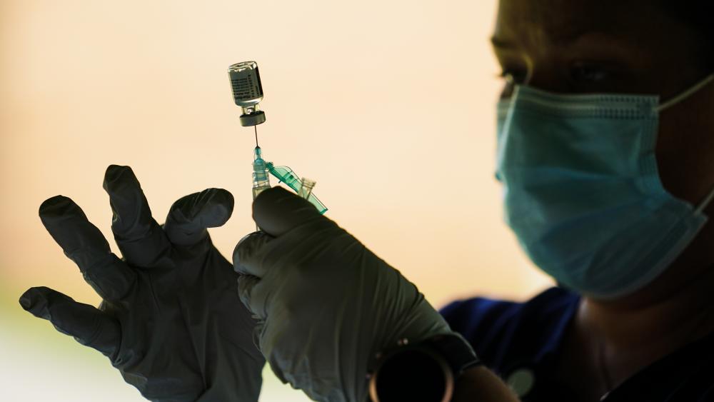 A syringe is prepared with the Pfizer COVID-19 vaccine at a clinic at the Reading Area Community College in Reading, Pa., Tuesday, Sept. 14, 2021. (AP Photo/Matt Rourke)