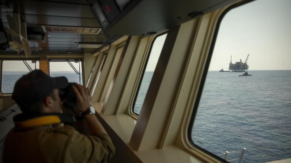 An Israeli Navy sailor looks at Israel's offshore Leviathan gas field from on board the Israeli Navy Ship Atzmaut as a submarine patrols in the Mediterranean Sea , Wednesday, Sept. 1, 2021.