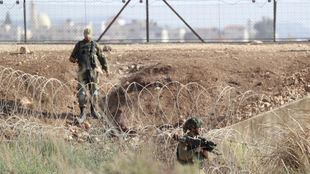 In this Sept. 12, 2021, file photo, Israeli soldiers take positions along the border between the northern West Bank near Jenin and Israel as they search for two Palestinians who broke out of a maximum-security prison. (AP Photo/Ariel Schalit, File)