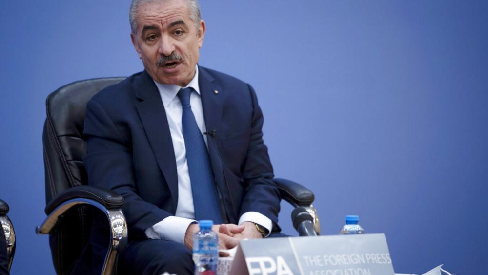 Palestinian Prime Minister Mohammad Shtayyeh, right, holds a briefing with members of the Foreign Press Association (FPA), in the West Bank city of Ramallah, Wednesday, Nov. 10, 2021. (AP Photo/Majdi Mohammed)