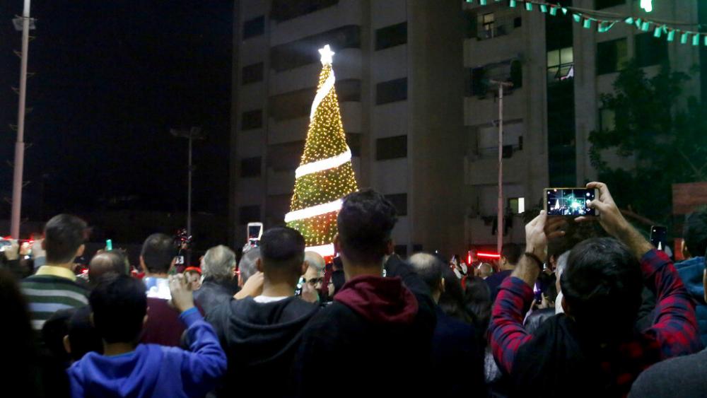FILE Palestinian Christians attend a Christmas tree lighting celebration in Gaza City, Tuesday, Dec. 3, 2019. (AP Photo/Hatem Moussa, File)