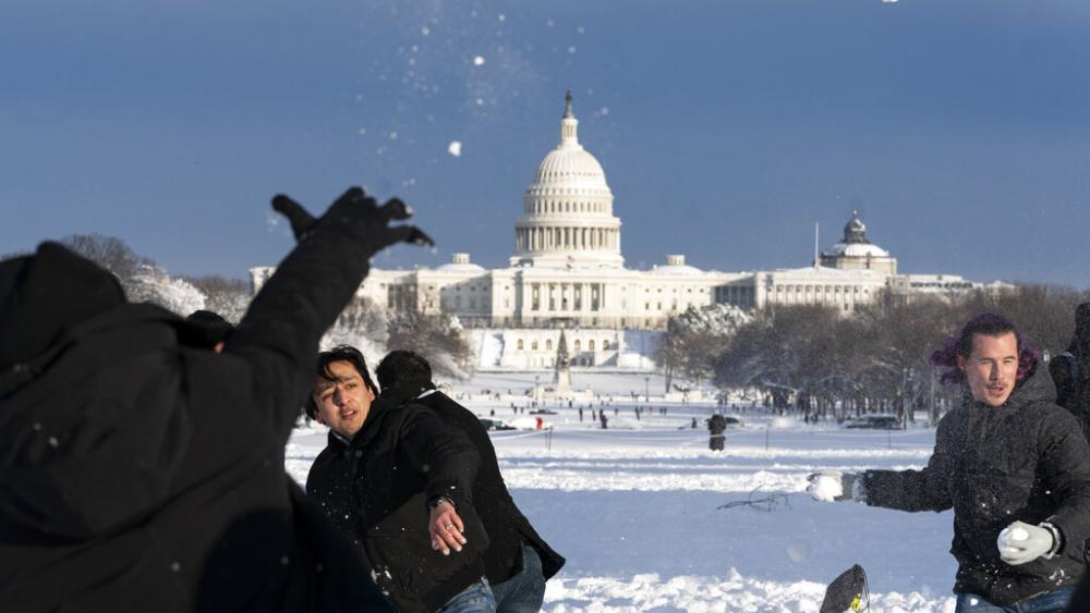 Snowballs fly during a snowball fight organized by the DC Snowball Fight Association, on the National Mall, Monday, Jan. 3, 2022, in Washington. (AP Photo/Alex Brandon)