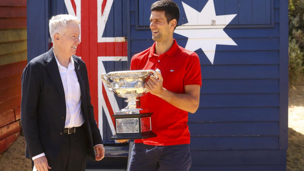 Serbia&#039;s Novak Djokovic stands with Australian Open tournament director Craig Tiley for a trophy photo shoot following his win the Australian Open tennis championships in Melbourne, Australia, Monday, Feb 22. AP Photo.